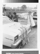 Students decorating college bowl team car