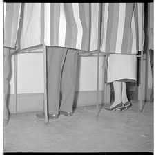 Shoes of people in voting booths