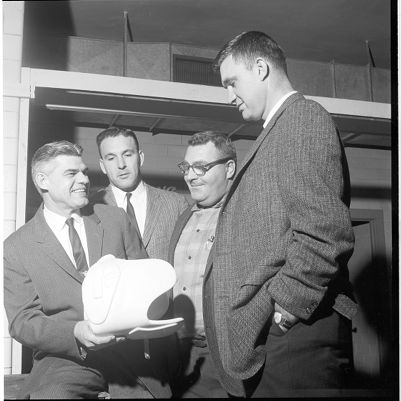 Coach Stas holding a piece of football equipment