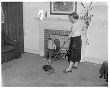 Woman cleans up after dust storm 