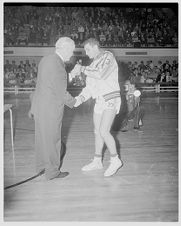 Basketball player accepts trophy