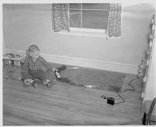 Polio victim plays with trains