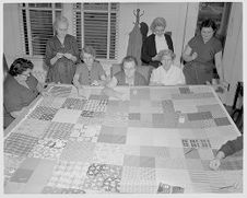 Women sewing quilt 