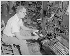 Man working on newspaper issue