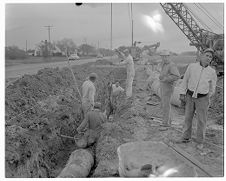 Men putting in pipe 