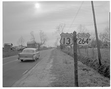 Cars passing by signs