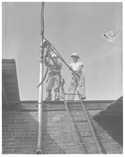 Men wiring building 