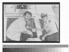 Robert Wagner and a U.S. Coast Guard Auxiliary member on a boat