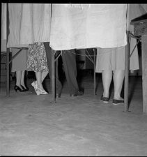 Shoes of people in voting booths