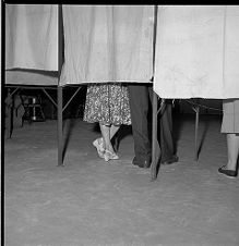 Shoes of people in voting booths