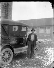 Man standing beside a car