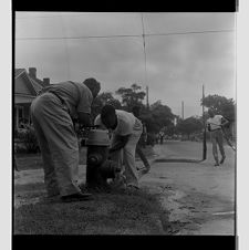 Firemen hooking up hose