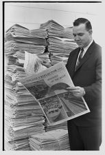 Man with a large stack of The Daily Reflector 