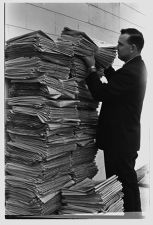 Man with a large stack of The Daily Reflector 