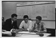 Men working on engineering drawing 