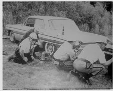 Men with guns behind car