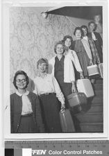 Sigma Sigma Sigma members on staircase with luggage