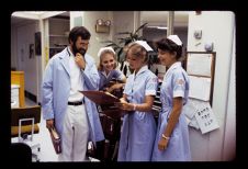 Two nursing students and an instructor with a patient