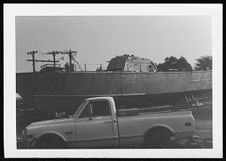 Osprey:  Portside view beside a truck.