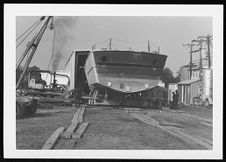 Osprey:  Stern view on land coming out of the warehouse