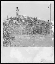 Port side view of unknown boat being built