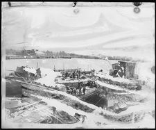 Over looking men working on deck of ship being built.