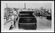 Small boat.  "Star Light.  New Bern, NC" tied to dock.  Starboard Stern view
