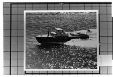 Navy.  Exterior View- Porside view of ship moving at fast pace.  Two men standing on the bow. American Flag flying on the stern.