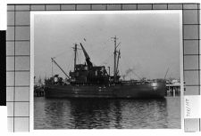 exterior view of Portside of unknown ship at dock.
