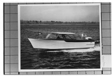 Starboard view of small unknown boat moving