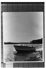 small unknown boat moving.  Portside view