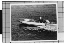 very small boat. Moving.  Portside view