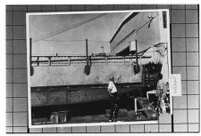 Two men observing boat