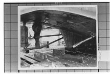 Underneath ship in dry dock.  View of propeller