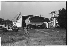 Osprey:  Stern view on land coming out of the warehouse