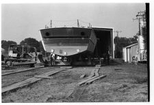 Osprey:  Stern view on land coming out of the warehouse