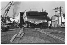 Osprey:  Stern view on land coming out of the warehouse