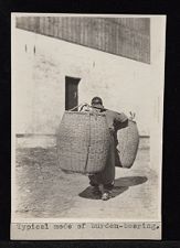 Chinese person carrying two large baskets