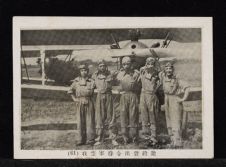 Five men stand in front of a propeller plane