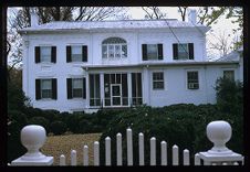 House with fence. Color photo.