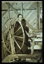 Woman spinning at wheel. Black and white photo. 