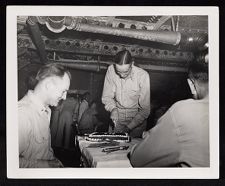 Capt. Cassidy cutting cake commemorating landing