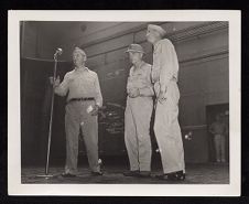 Three men at microphone including Admirals Cassidy, and Halsey 