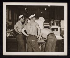 Navy crew working around ship 