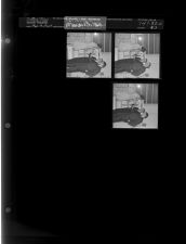 Man handing bottle of tincture to woman (3 Negatives) (March 13, 1964) [Sleeve 43, Folder c, Box 32]