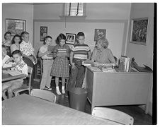 Children in line at their teacher's desk