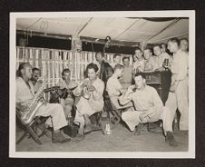 Photograph of Marines listening to a band