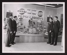 Shoe store window display with Pepsi-Cola advertisement