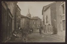 Soldiers in uniform walking down a city street