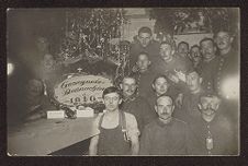 Group of soldiers standing around a Christmas tree